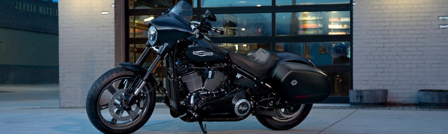 Black 2022 Harley-Davidson® motorcycle parked outside of a building